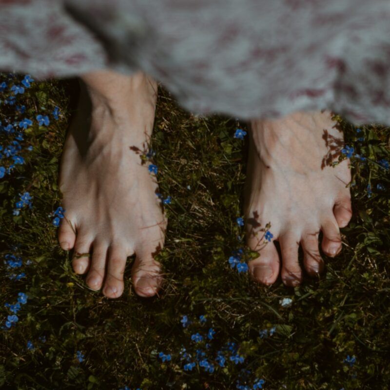 persons feet on green grass
