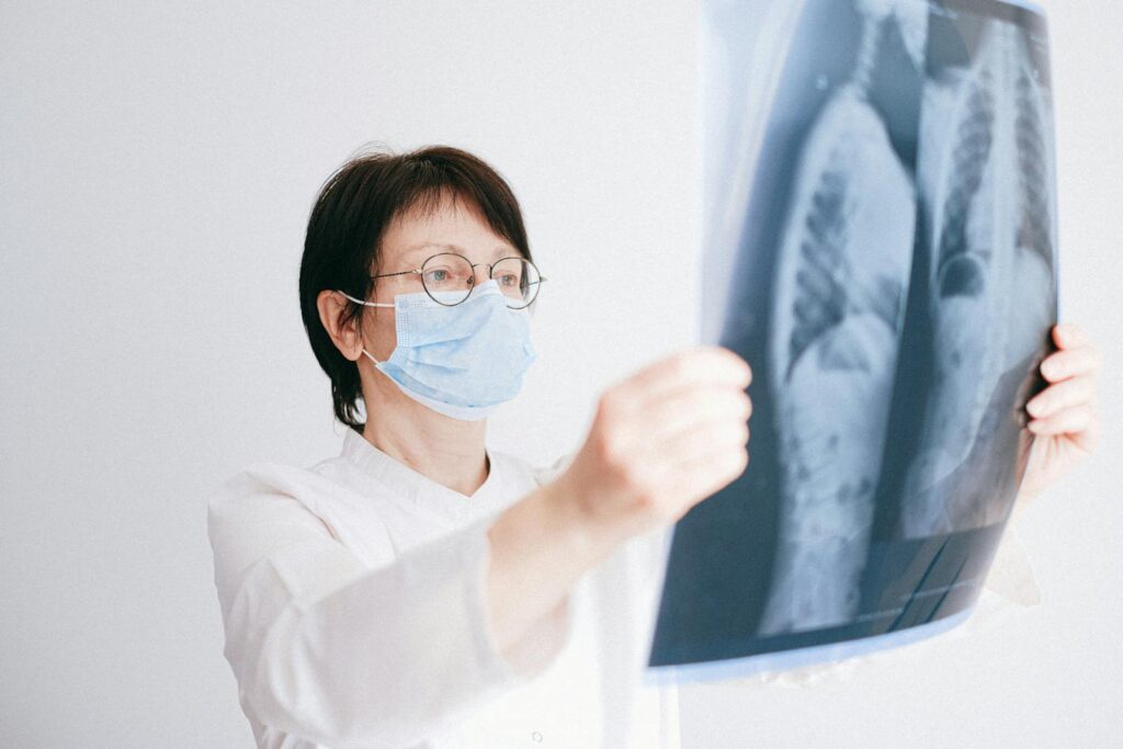 Doctor Looking at Lung Scans She Is Holding