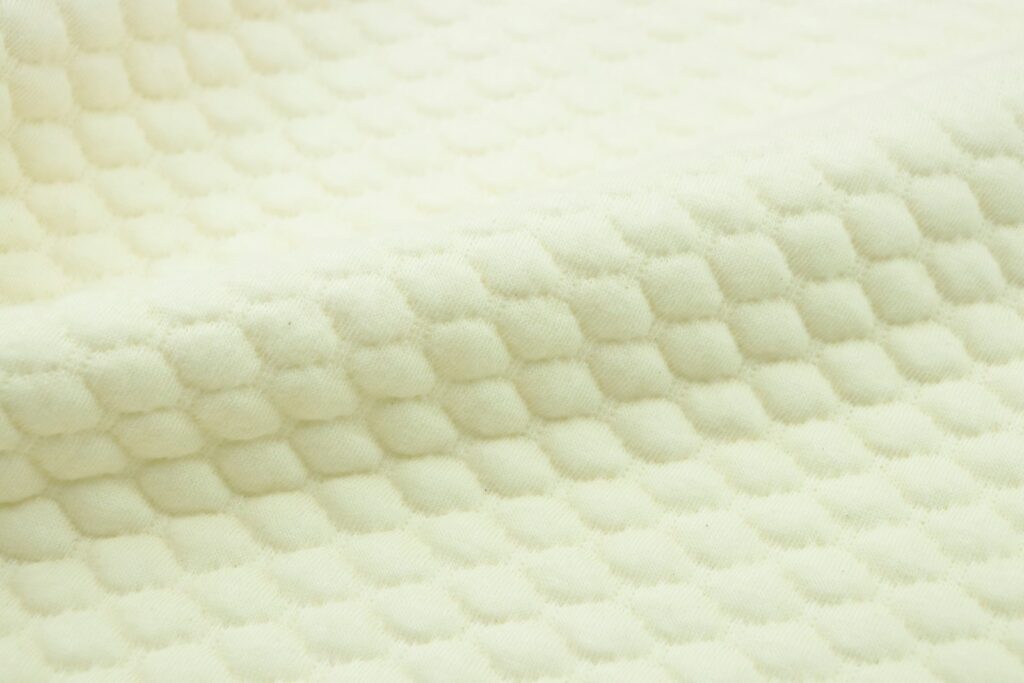 a close up of a mattress with a white background