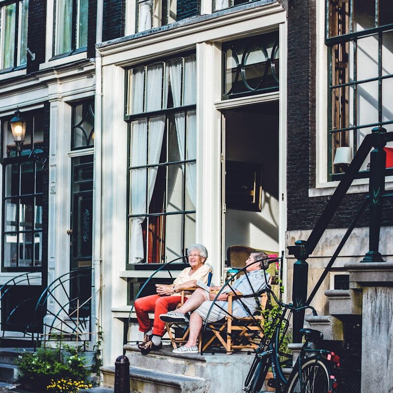 two person sitting in front of door