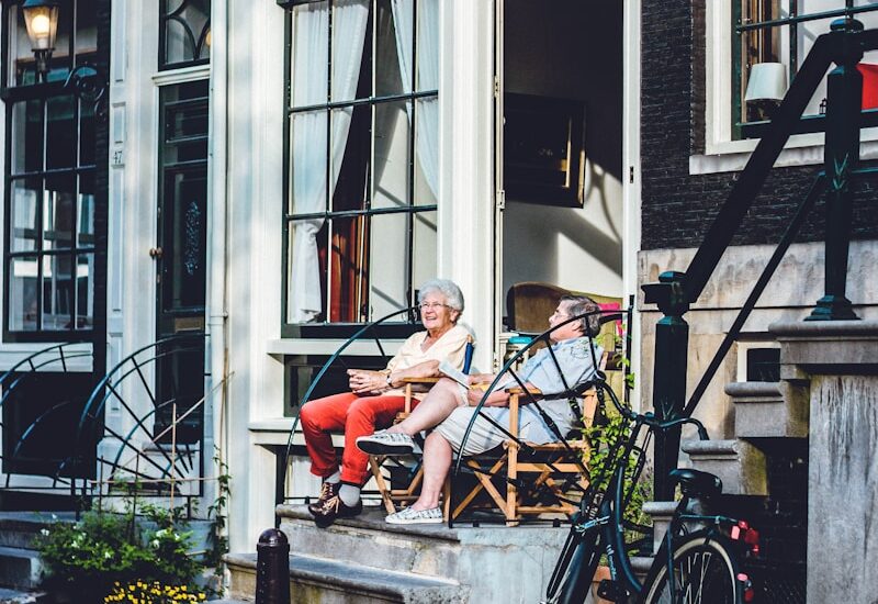 two person sitting in front of door