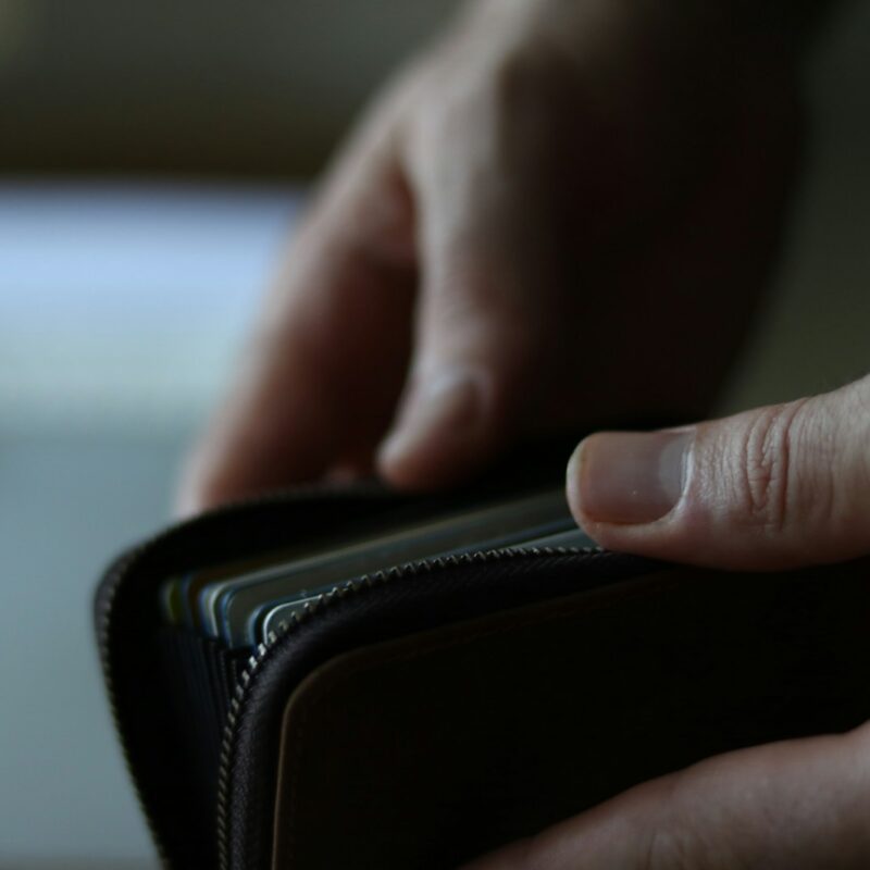 a person holding a wallet in their hand