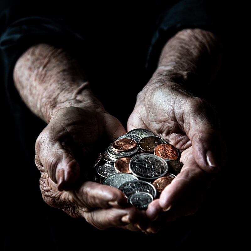 person holding silver round coins