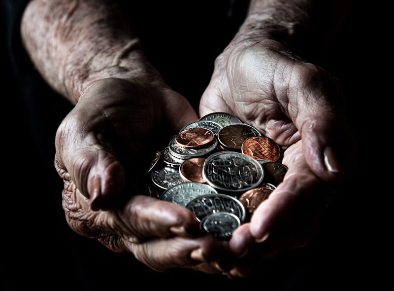 person holding silver round coins