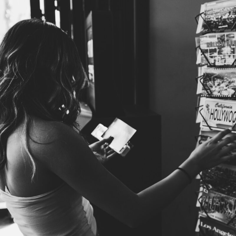 grayscale photo of woman holding magazine