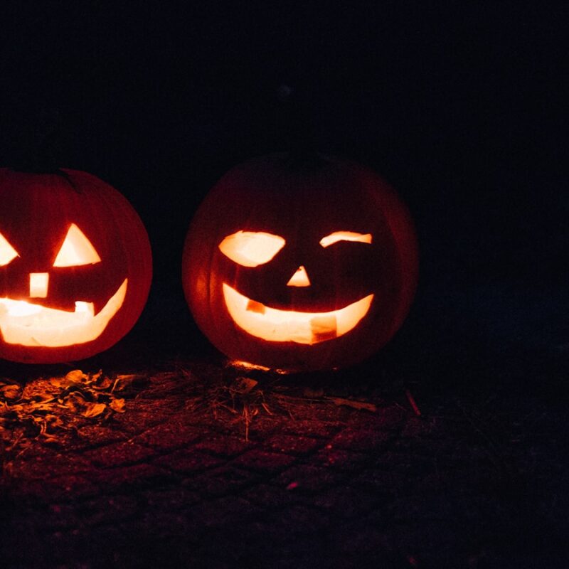 two lighted jack-o-lanterns during night time